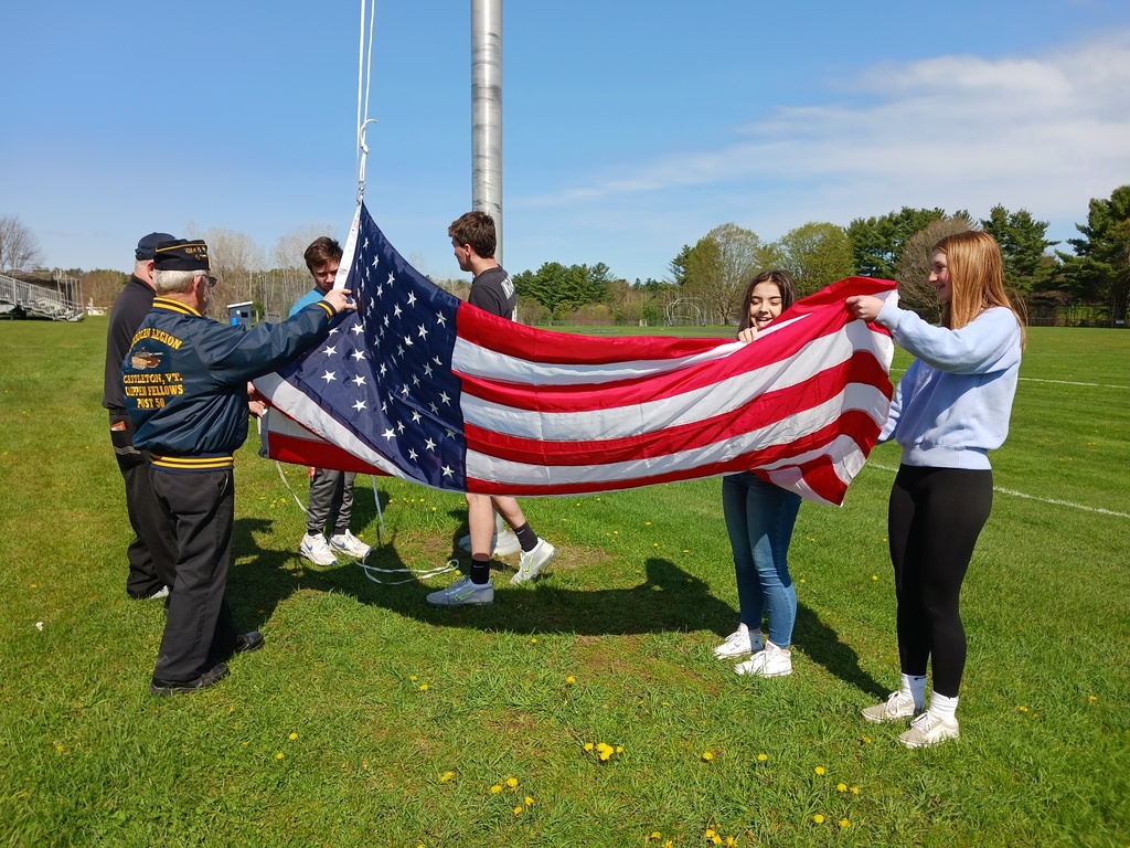 Unfolding the flag and fastening it to the pole.